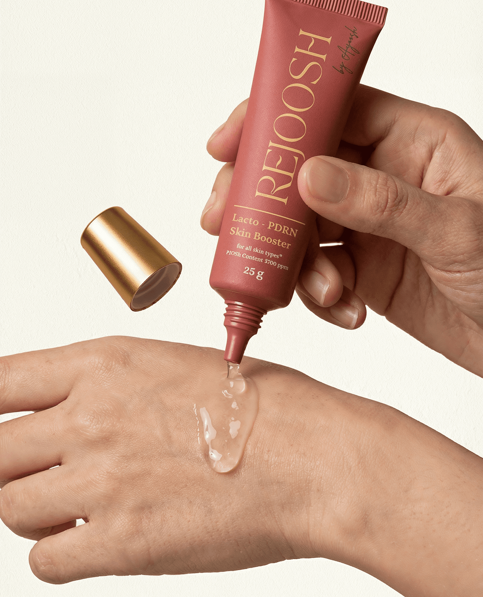 A hand holding an AYOOSH product